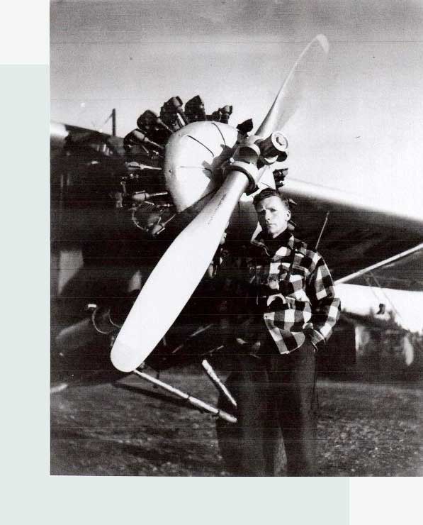 Herman Peterson standing in front of Fairchild 71, CF-AWV at Altlin Airport
